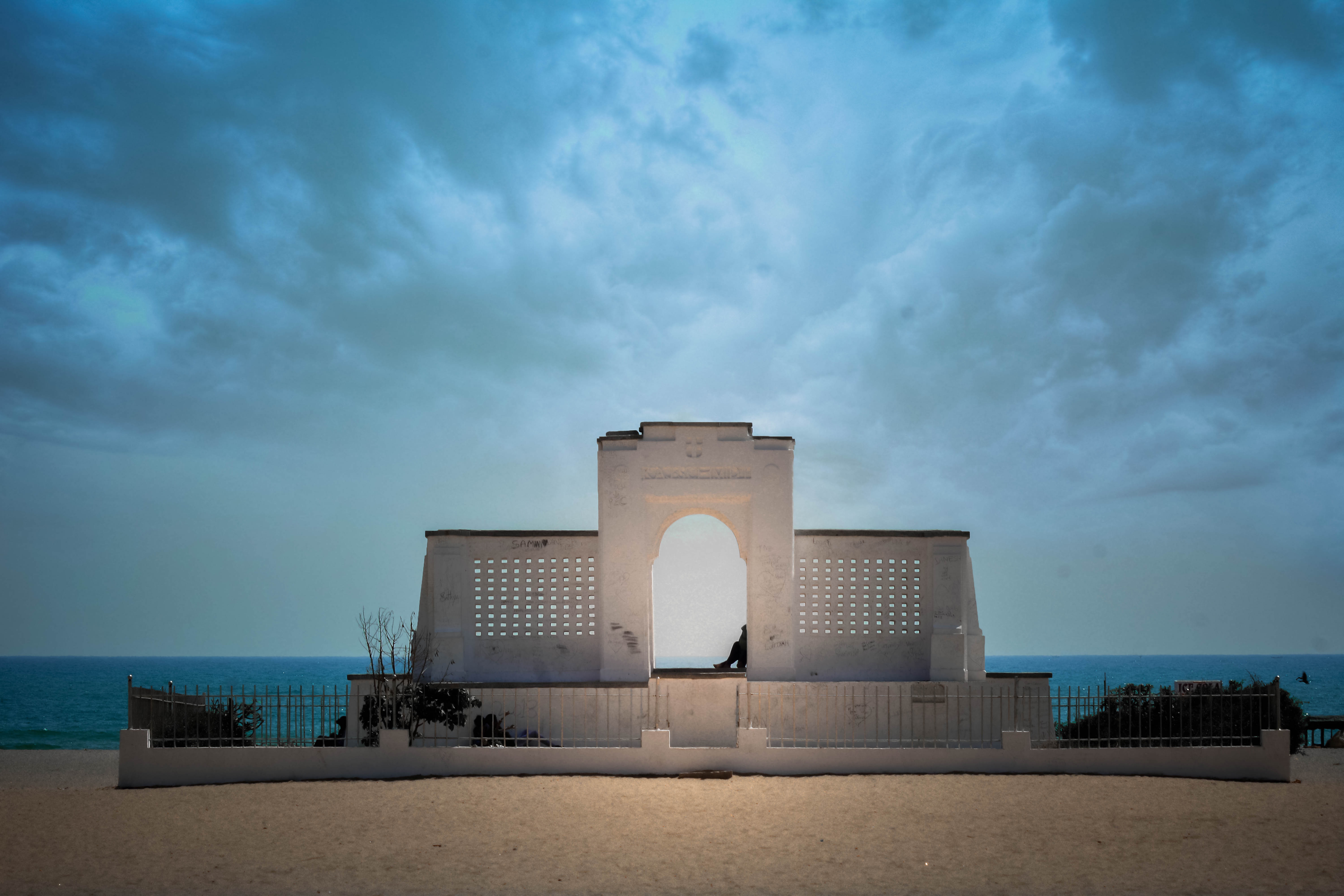 The war memorial on Marina Beach, Madras, against a heavy sky.